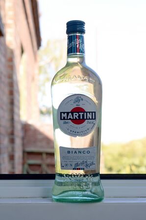 KHARKOV, UKRAINE - SEPTEMBER 23, 2019: Bottle of Vermouth Martini Rossi close up logo on a green trees background. Martini is a brand of Italian vermouth since 1863のeditorial素材