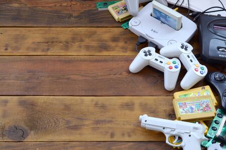 KHARKOV, UKRAINE - SEPTEMBER 18, 2019: Old 8-bit video game console and many gaming accessories like...