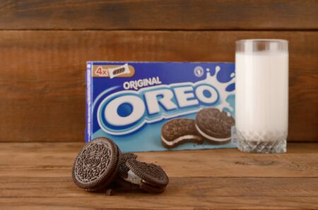 KHARKOV, UKRAINE - SEPTEMBER 8, 2019: Many OREO sandwich cream biscuits with pack and milk glass on...