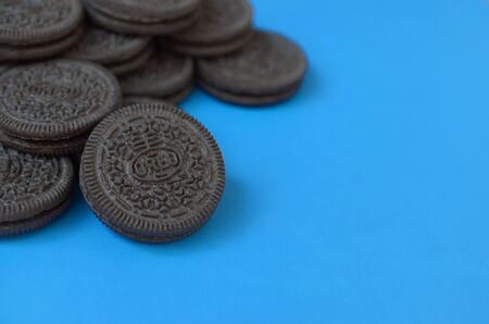 KHARKOV, UKRAINE - SEPTEMBER 8, 2019: Many OREO sandwich cream biscuits on blue background. Oreo is a sandwich cookie with a sweet cream is the best selling cookie in the USのeditorial素材