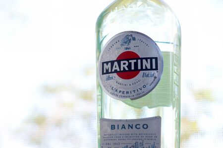 KHARKOV, UKRAINE - SEPTEMBER 23, 2019: Bottle of Vermouth Martini Rossi close up logo on a green trees background. Martini is a brand of Italian vermouth since 1863のeditorial素材