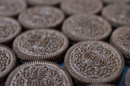 KHARKOV, UKRAINE - SEPTEMBER 8, 2019: Many OREO sandwich cream biscuits close up on blue background. Oreo is a sandwich cookie with a sweet cream is the best selling cookie in the USのeditorial素材