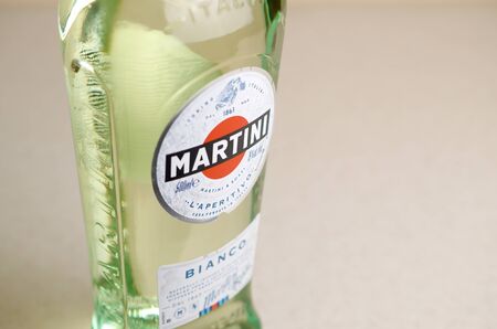 KHARKOV, UKRAINE - SEPTEMBER 23, 2019: Bottle of Vermouth Martini Rossi close up logo on beige wall background. Martini is a brand of Italian vermouth since 1863のeditorial素材