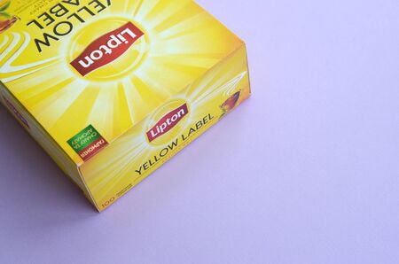 KHARKOV, UKRAINE - OCTOBER 4, 2019: Lipton Yellow Label black tea pack on pastel lilac surface close...
