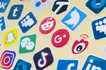 KHARKOV, UKRAINE - OCTOBER 17, 2019: Many paper icons with logo of most popular social networks and smartphone apps for chat and conversations onlineのeditorial素材