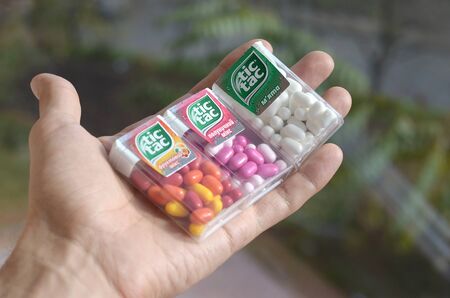 KHARKOV, UKRAINE - OCTOBER 26, 2019: Hand holds three Tic Tac Candy packages of different tastes close up. Tic tac is popular due its minty fresh taste. Hard mints produced by Ferrero since 1968のeditorial素材
