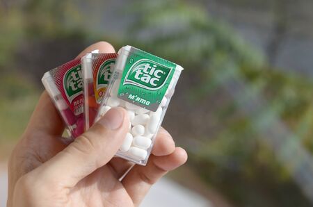KHARKOV, UKRAINE - OCTOBER 26, 2019: Hand holds three Tic Tac Candy packages of different tastes...