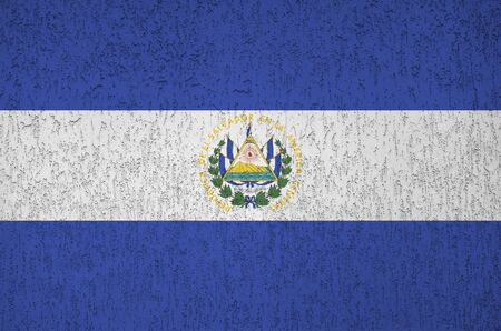 El Salvador flag depicted in bright paint colors on old relief plastering wall close up. Textured banner on rough backgroundの写真素材
