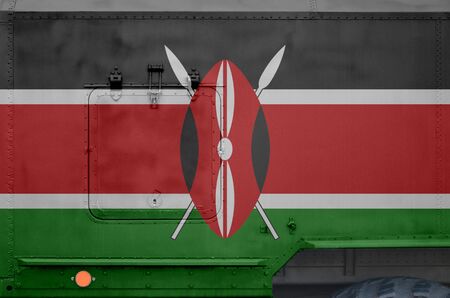 Kenya flag depicted on side part of military armored truck close up. Army forces vehicle conceptual...