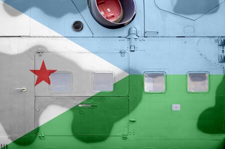 Djibouti flag depicted on side part of military armored helicopter close up. Army forces aircraft conceptual backgroundの写真素材