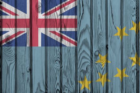 Tuvalu flag depicted in bright paint colors on old wooden wall close up. Textured banner on rough backgroundの写真素材