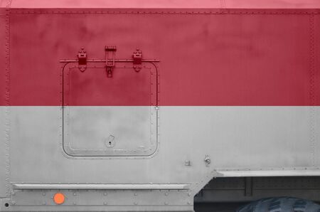 Indonesia flag depicted on side part of military armored truck close up. Army forces vehicle conceptual backgroundの写真素材