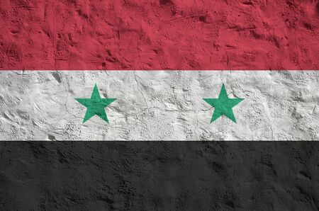 Syria flag depicted in bright paint colors on old relief plastering wall close up. Textured banner on rough backgroundの写真素材