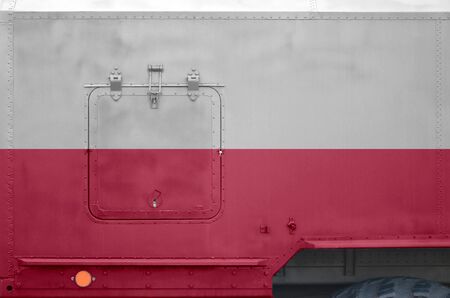 Poland flag depicted on side part of military armored truck close up. Army forces vehicle conceptual backgroundの写真素材