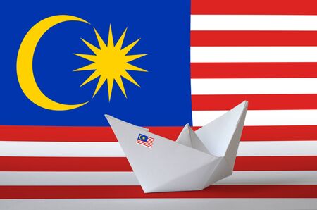 Malaysia flag depicted on paper origami ship closeup. Oriental handmade arts conceptの写真素材