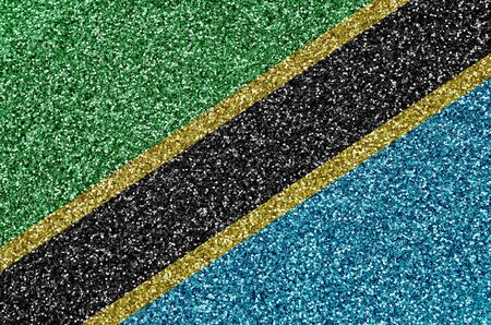 Tanzania flag depicted on many small shiny sequins. Colorful festival background for disco partyの写真素材