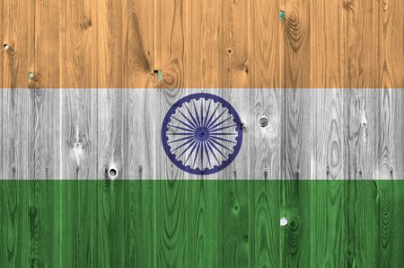 India flag depicted in bright paint colors on old wooden wall close up. Textured banner on rough backgroundの写真素材