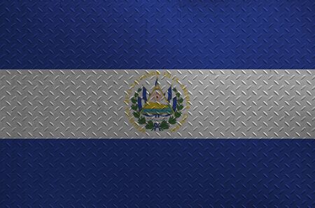 El Salvador flag depicted in paint colors on old brushed metal plate or wall close up. Textured banner on rough backgroundの写真素材
