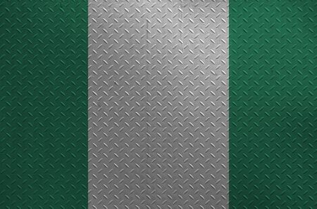 Nigeria flag depicted in paint colors on old brushed metal plate or wall close up. Textured banner on rough backgroundの写真素材
