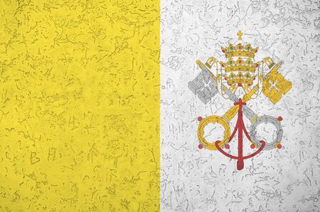 Vatican City State flag depicted in bright paint colors on old relief plastering wall close up. Textured banner on rough backgroundの写真素材
