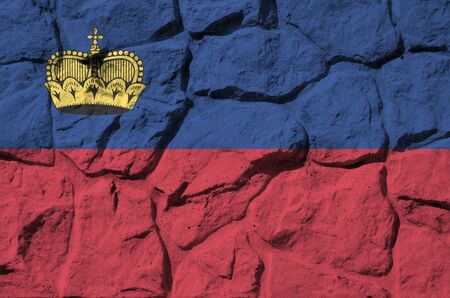 Liechtenstein flag depicted in paint colors on old stone wall close up. Textured banner on rock wall backgroundの写真素材
