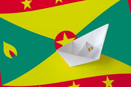 Grenada flag depicted on paper origami ship closeup. Oriental handmade arts conceptの写真素材