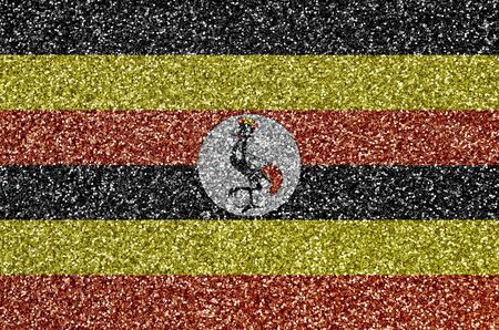 Uganda flag depicted on many small shiny sequins. Colorful festival background for disco partyの写真素材