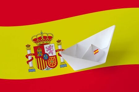Spain flag depicted on paper origami ship closeup. Oriental handmade arts concept