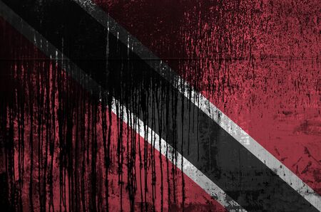 Trinidad and Tobago flag depicted in paint colors on old and dirty oil barrel wall close up. Textured banner on rough backgroundの写真素材