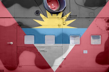 Antigua and Barbuda flag depicted on side part of military armored helicopter close up. Army forces aircraft conceptual backgroundの写真素材