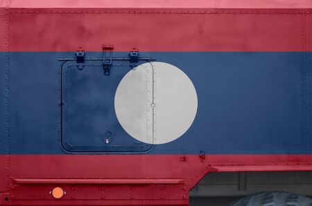 Laos flag depicted on side part of military armored truck close up. Army forces vehicle conceptual backgroundの写真素材