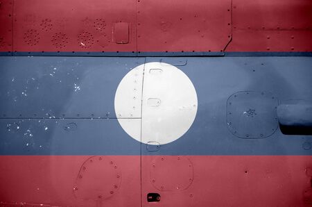 Laos flag depicted on side part of military armored helicopter close up. Army forces aircraft conceptual backgroundの写真素材