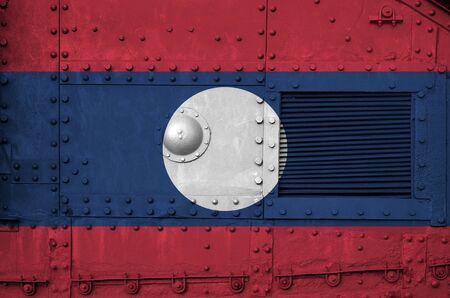 Laos flag depicted on side part of military armored tank close up. Army forces conceptual backgroundの写真素材