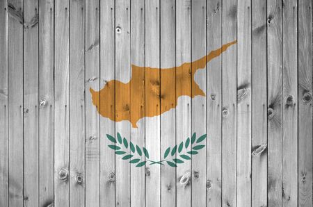 Cyprus flag depicted in bright paint colors on old wooden wall close up. Textured banner on rough backgroundの写真素材
