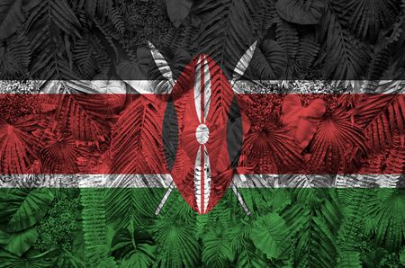 Kenya flag depicted on many leafs of monstera palm trees. Trendy fashionable backgroundの写真素材