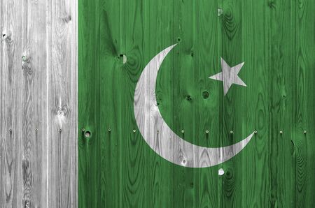 Pakistan flag depicted in bright paint colors on old wooden wall close up. Textured banner on rough backgroundの写真素材