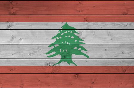 Lebanon flag depicted in bright paint colors on old wooden wall close up. Textured banner on rough backgroundの写真素材