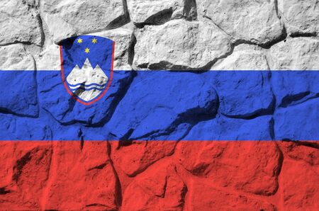 Slovenia flag depicted in paint colors on old stone wall close up. Textured banner on rock wall backgroundの写真素材
