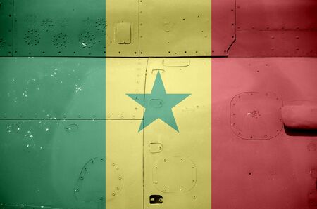 Senegal flag depicted on side part of military armored helicopter close up. Army forces aircraft conceptual backgroundの写真素材