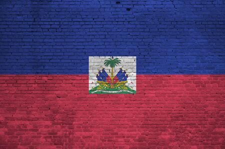 Haiti flag depicted in paint colors on old brick wall close up. Textured banner on big brick wall masonry backgroundの写真素材