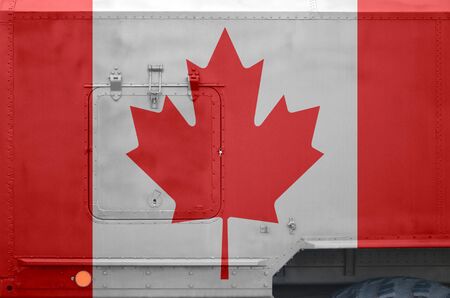 Canada flag depicted on side part of military armored truck close up. Army forces vehicle conceptual backgroundの写真素材