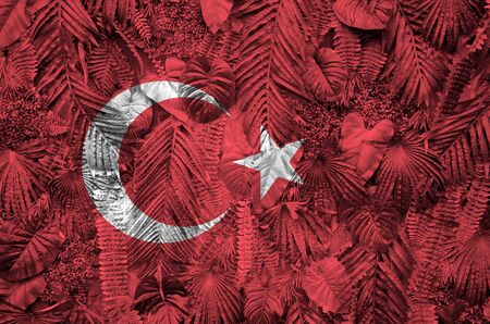 Turkey flag depicted on many leafs of monstera palm trees. Trendy fashionable backgroundの写真素材