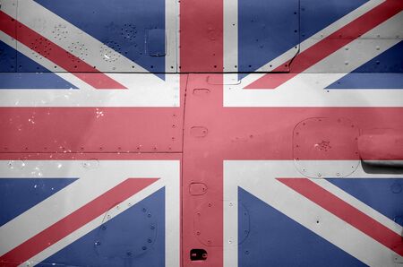 Great britain flag depicted on side part of military armored helicopter close up. Army forces aircraft conceptual backgroundの写真素材