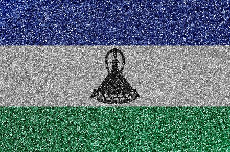 Lesotho flag depicted on many small shiny sequins. Colorful festival background for disco partyの写真素材