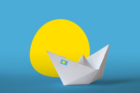 Palau flag depicted on paper origami ship closeup. Oriental handmade arts concept