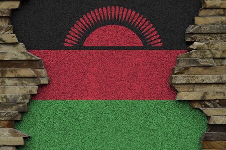 Malawi flag depicted in paint colors on old stone wall close up. Textured banner on rock wall backgroundの写真素材