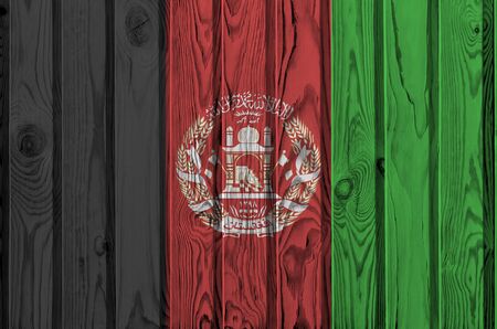 Afghanistan flag depicted in bright paint colors on old wooden wall close up. Textured banner on rough backgroundの写真素材