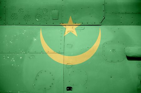 Mauritania flag depicted on side part of military armored helicopter close up. Army forces aircraft conceptual backgroundの写真素材