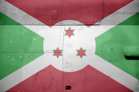 Burundi flag depicted on side part of military armored helicopter close up. Army forces aircraft conceptual backgroundの写真素材