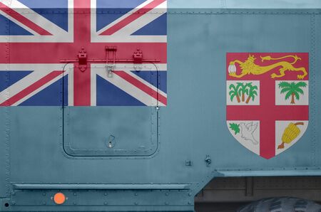 Fiji flag depicted on side part of military armored truck close up. Army forces vehicle conceptual...